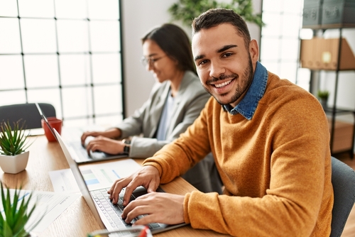 Two,Business,Workers,Smiling,Happy,Working,Sitting,On,Desk,At